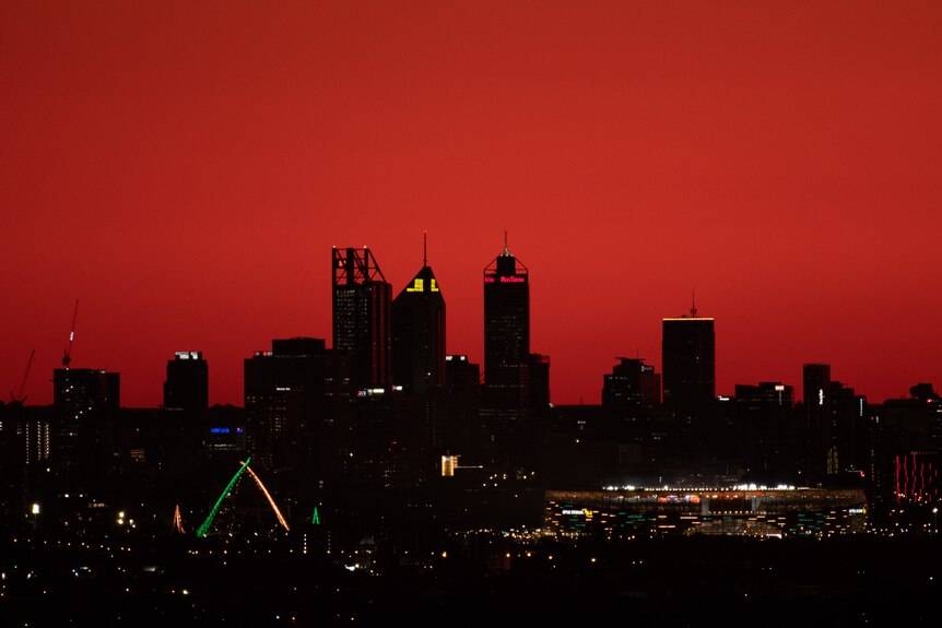 Perth's CBD against a dark red sky