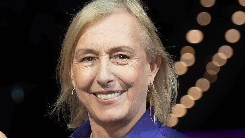 Martina Navratilova smiles while presenting a trophy at the WTA Finals in Fort Worth, Texas