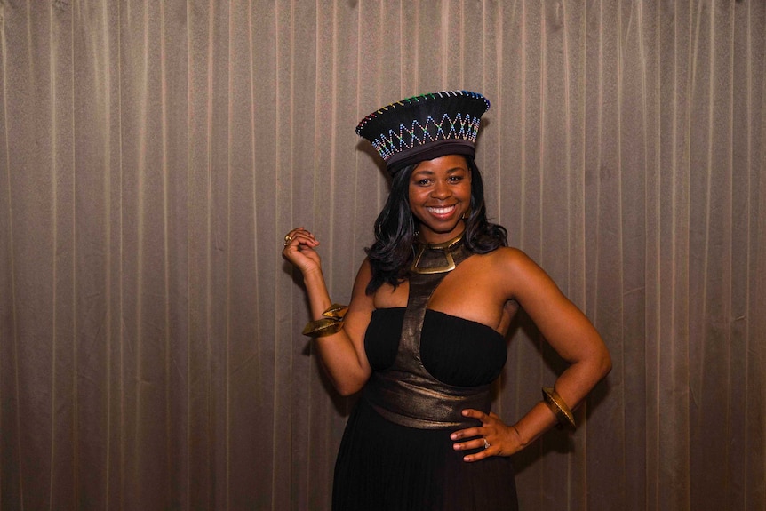 A young African woman poses for a portrait.