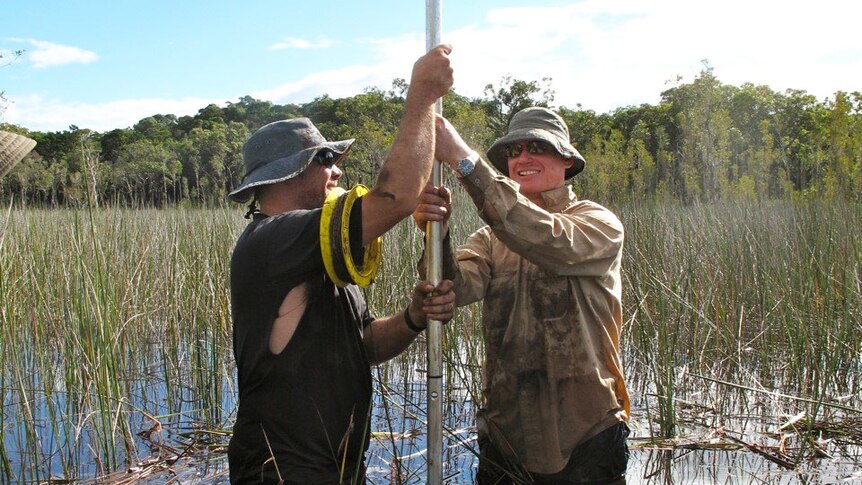 Researchers Cameron Barr and Jonathan Marshall gather sediment core samples at Fern Gully Lagoon North Stradbroke Island.
