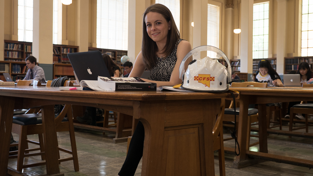 CFS volunteer and University of Adelaide law student Hannah Cox sits in the Uni library.