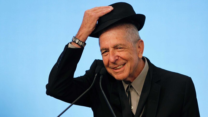 Leonard Cohen tips his hat to the audience
