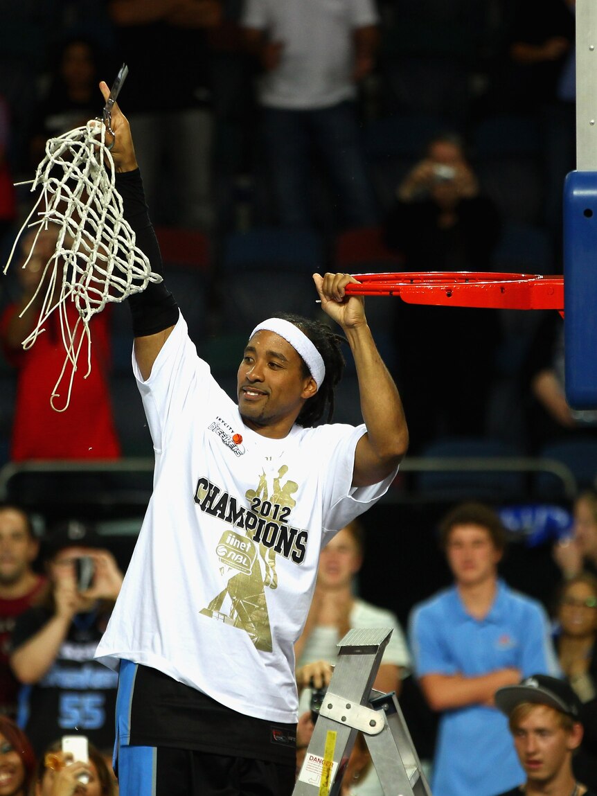 Five times a champion ... series MVP CJ Bruton lifts the net in Auckland.