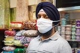 Harpreet Singh wears a facemask with longer elastic straps and a larger pouch.
