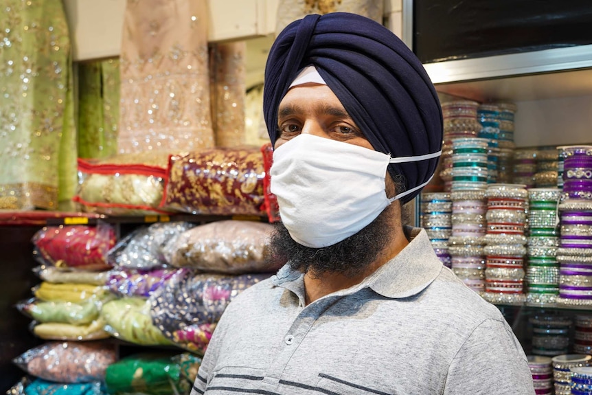 Harpreet Singh wears a facemask with longer elastic straps and a larger pouch.