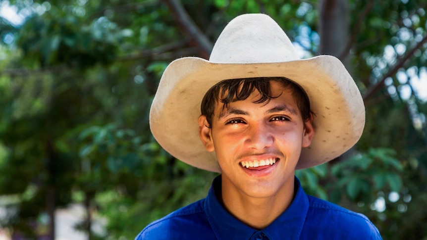 Kununurra teenager Mikey Cox poses, wearing a cowboy hat.