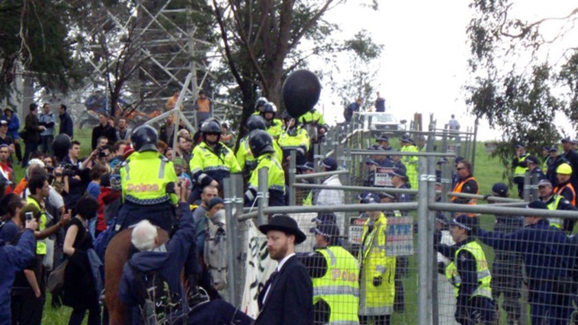 Climate change activists try to breach police barricades outside the Hazelwood power station in Victoria's Latrobe Valley