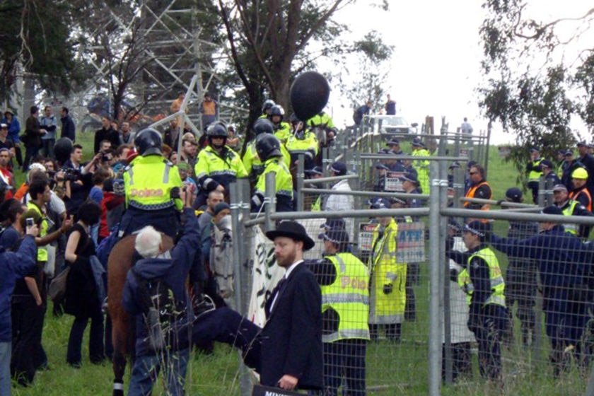 Climate change activists try to breach police barricades outside the Hazelwood power station in Victoria's Latrobe Valley
