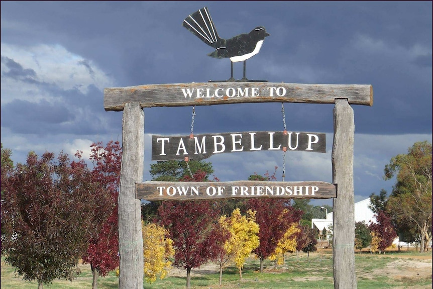 A wooden sign at the entrance to a town that reads "Tambellup: Town of Friendship".