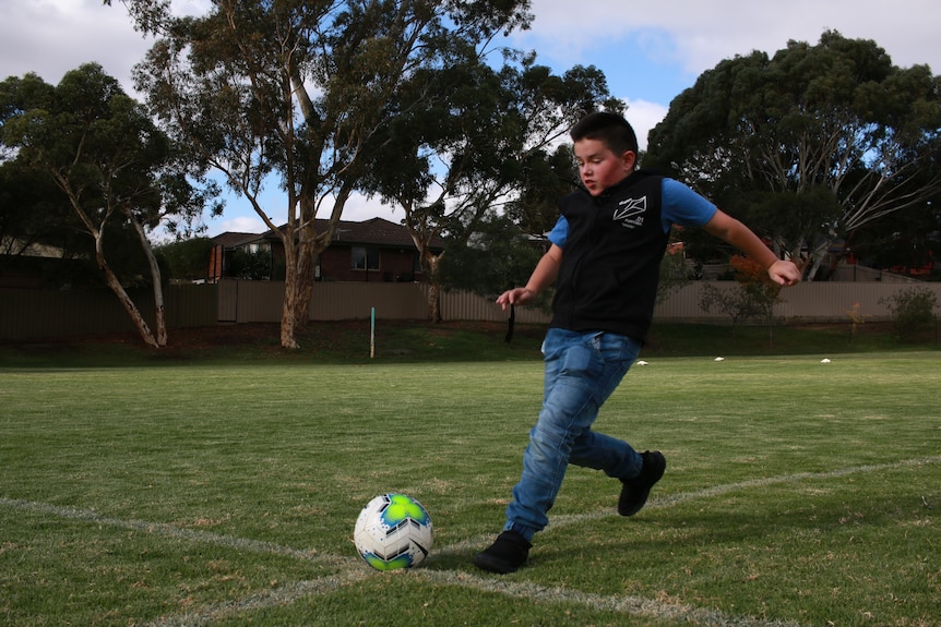 A boy playing football.