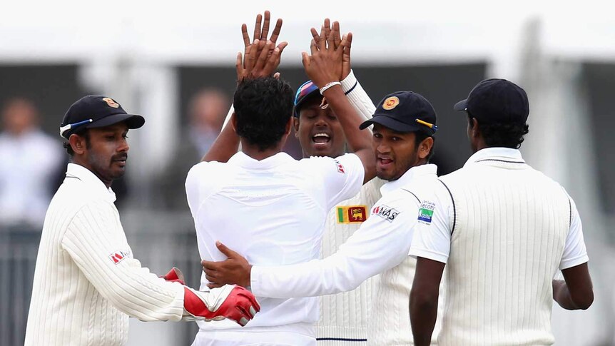 Early breakthrough... Sri Lanka celebrates the wicket of Ed Cowan.