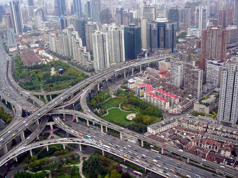 Aerial image of Puxi Viaduct in Shanghai withy network of roads coming together buildings and gardens in between