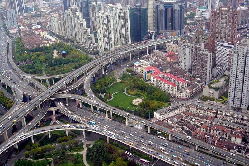 Aerial image of Puxi Viaduct in Shanghai withy network of roads coming together buildings and gardens in between