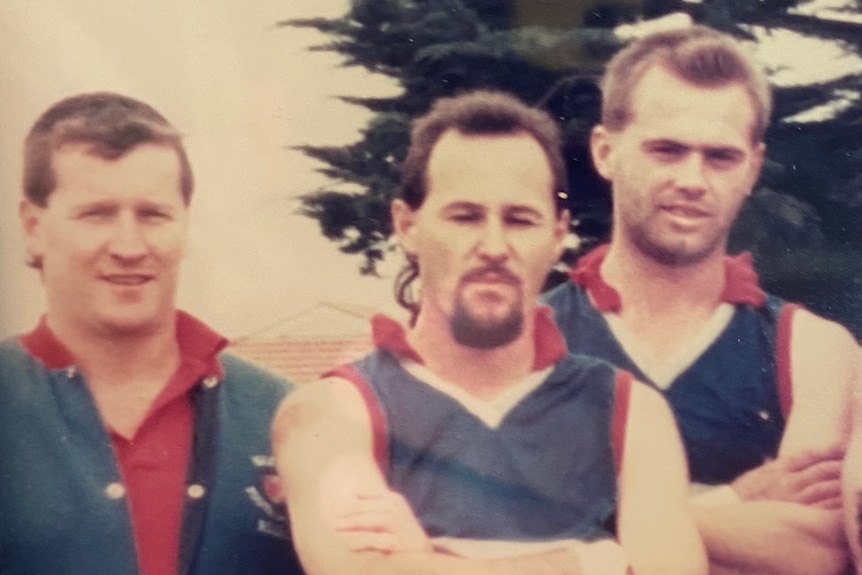 Greg Robinson (left) and Robert Stal (right) in an Aussie rules team photo from 1993.