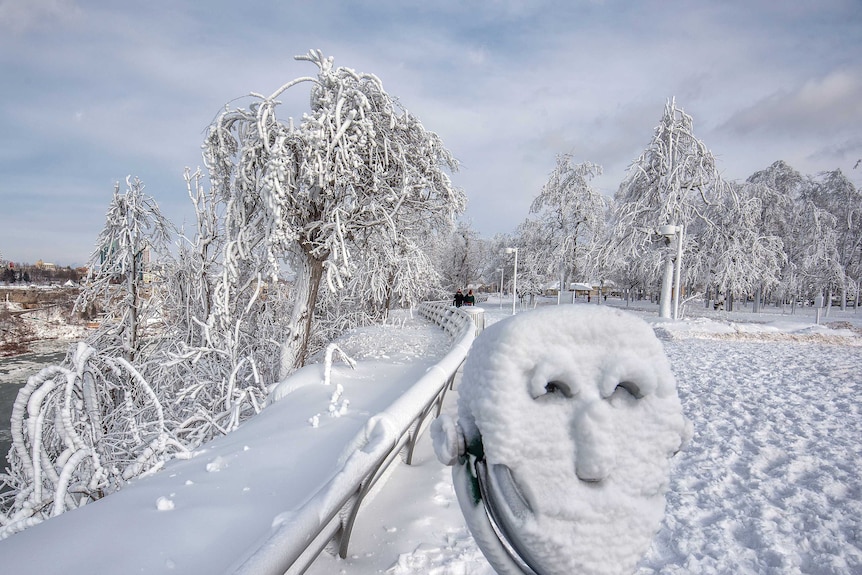 A coin operated binocular is covered with snow on Goat Island at Niagara Falls State Park.