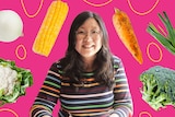 Jennifer Wong surrounded by vegetables like cauliflower, corn, onion, sweet potato, spring onion, broccoli.