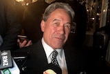New Zealand First leader Winston Peters speaks to media on arrival at his election campaign party