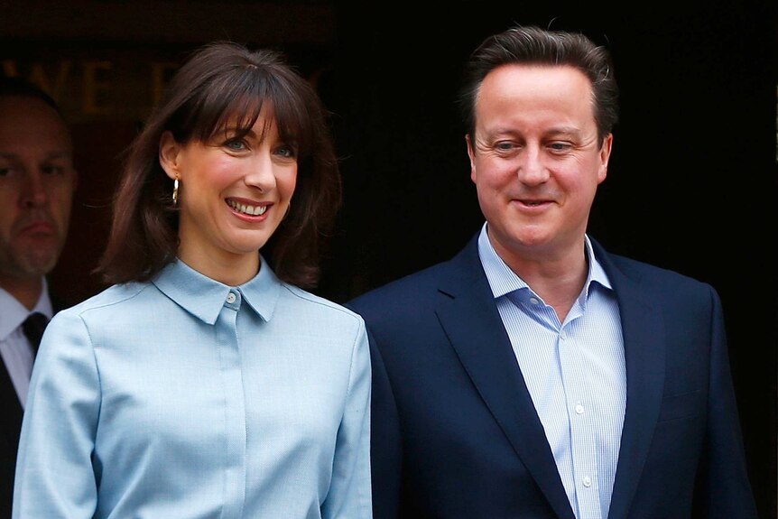 David Cameron and his wife Samantha leave a polling station after voting in central England.