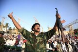 An anti-Gaddafi fighter shouts during the Eid al-Fitr prayer in Tripoli.
