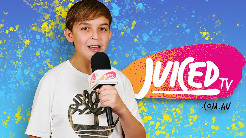 Young TV presenter Keanu holds a microphone. Juiced TV logo in the background.