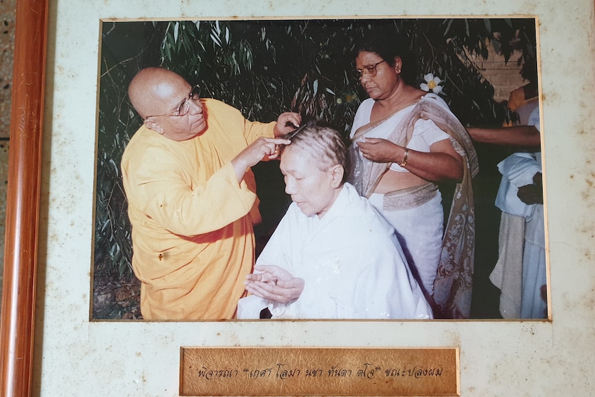 A woman's head is shaved.