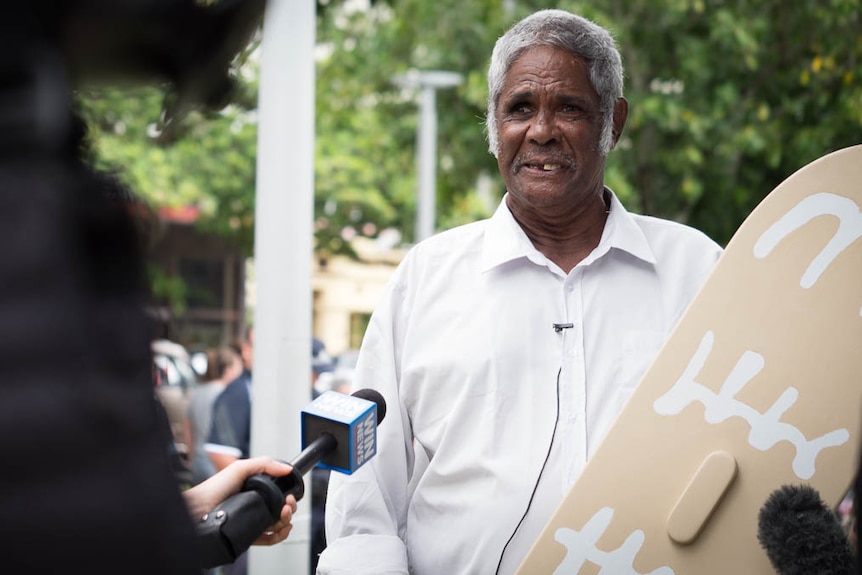 Aboriginal man talking to journalist