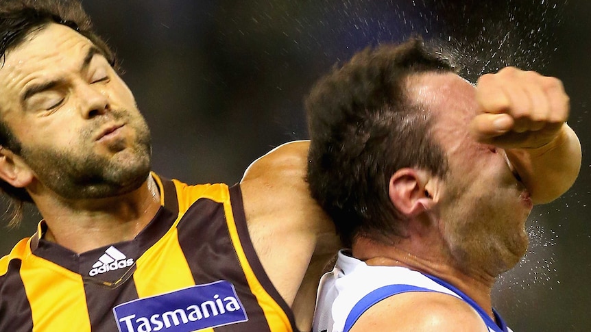 Hawthorn's Jordan Lewis strikes North Melbourne's Todd Goldstein in the head at Docklands.