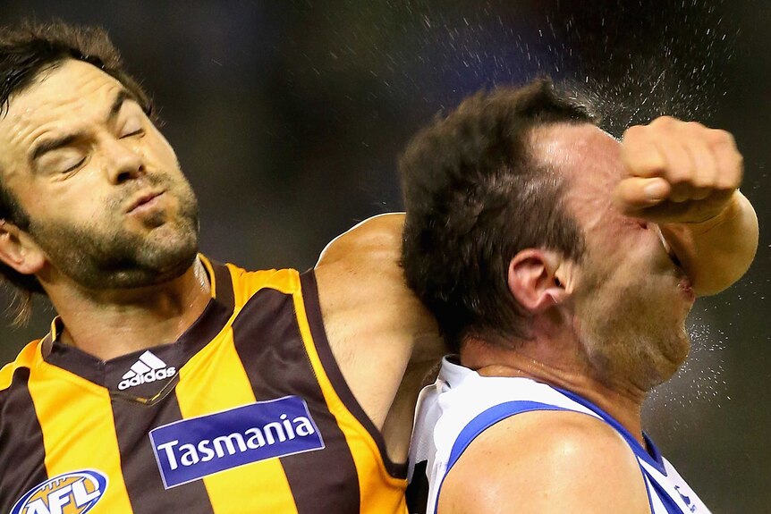 Hawthorn's Jordan Lewis collects North Melbourne's Todd Goldstein in the head at Docklands.
