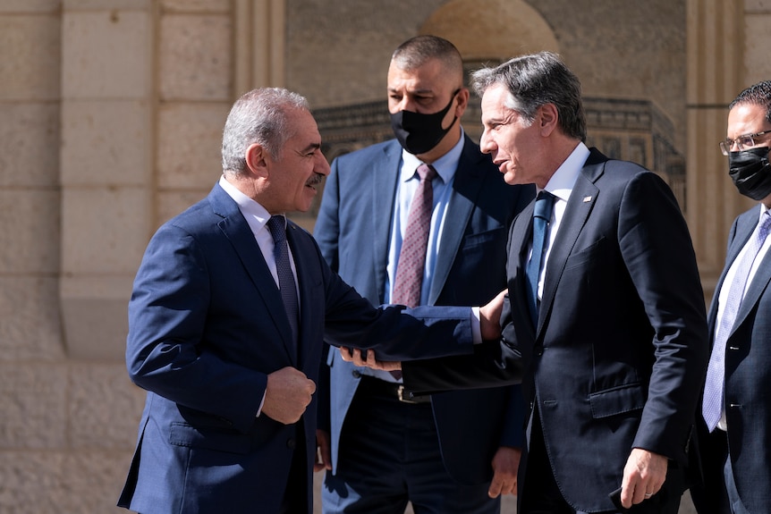 US Secretary of State Blinken shakes hands with Palestinian PM Mohammad Shtayyeh