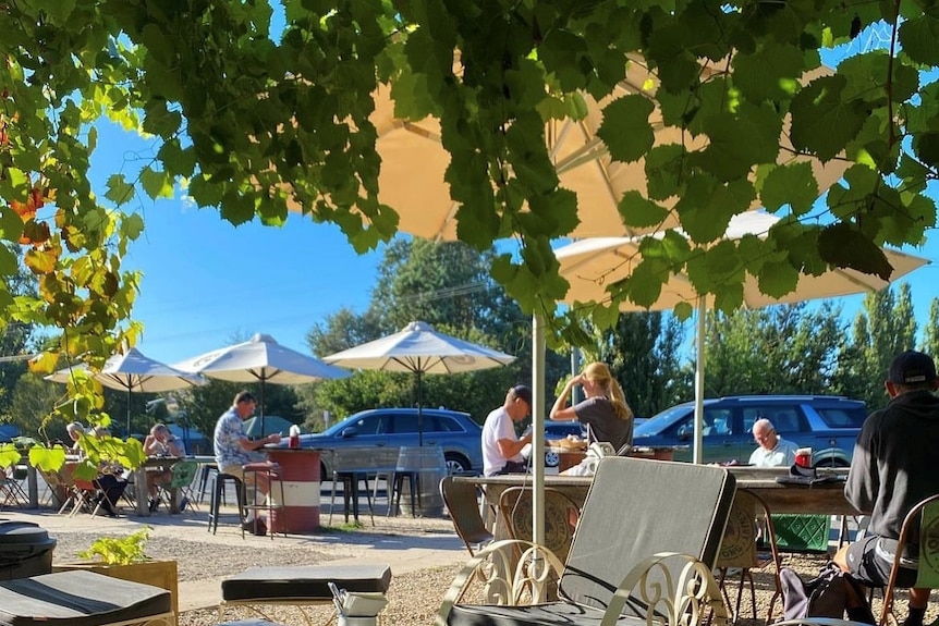 People sit at cafe tables