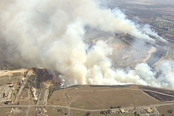 Smoke rising over a valley.