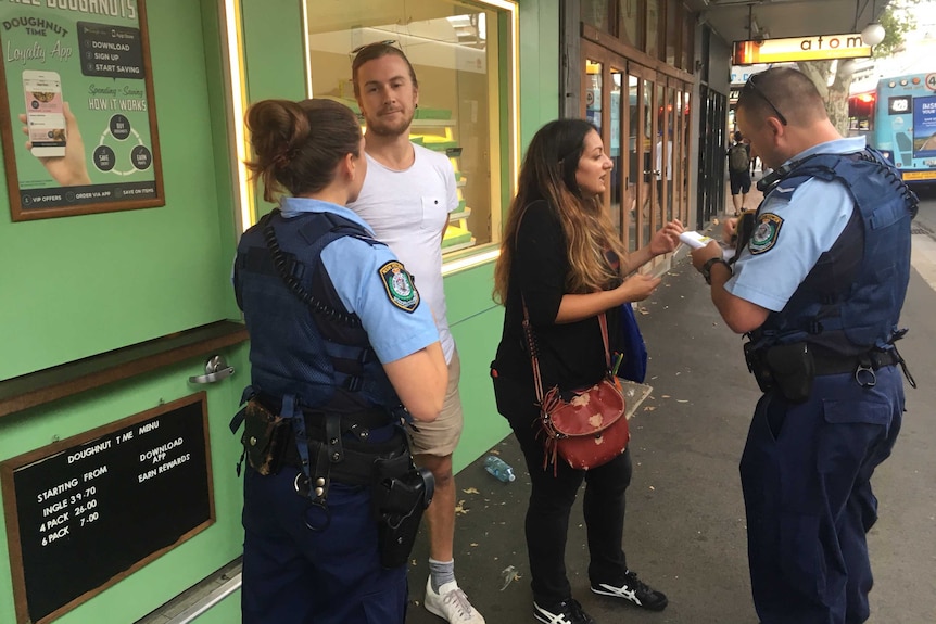Police move on protesters outside a Doughnut Time store in Newtown, Sydney.