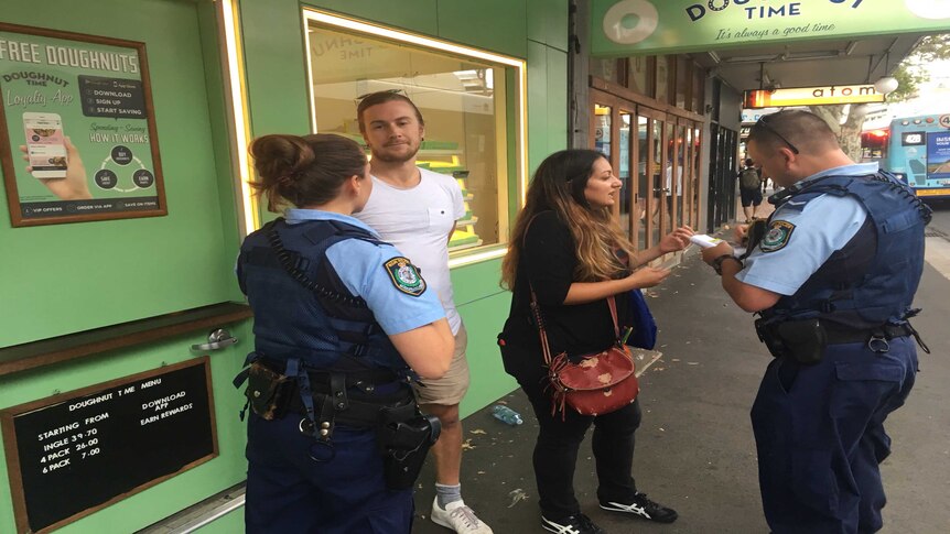 Police move on protesters outside a Doughnut Time store in Newtown, Sydney.