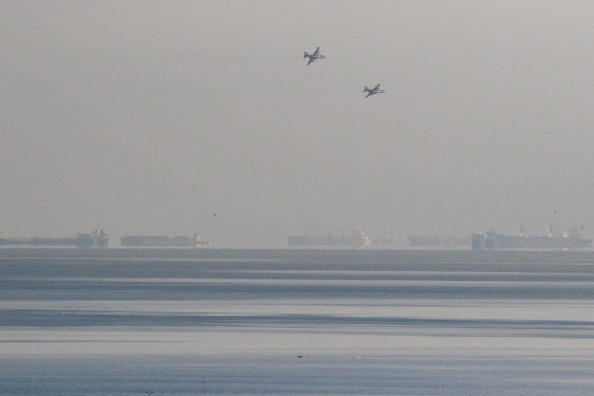 Two Russian fighter jets are seen flying in the distance.