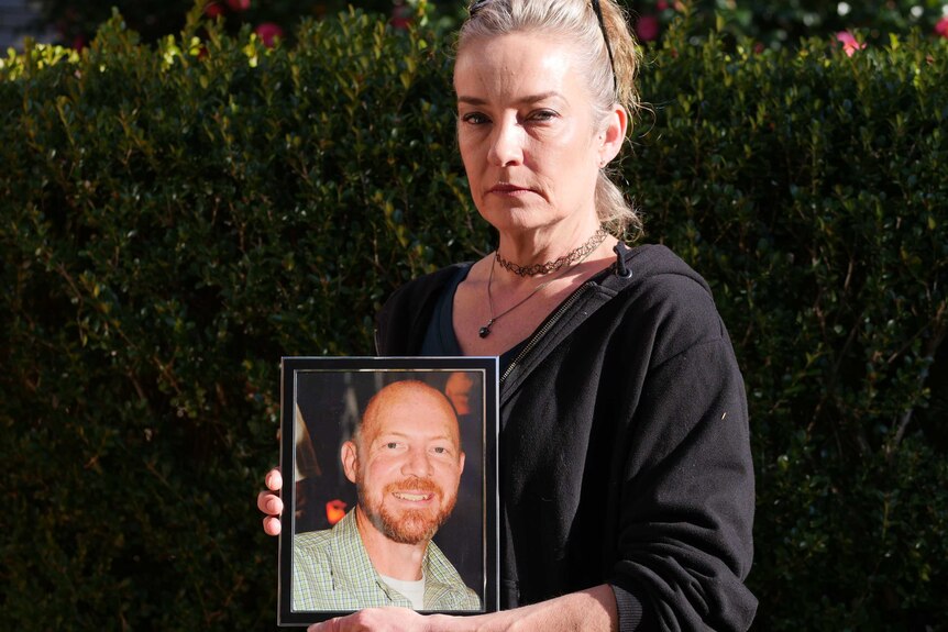 Sonia Van Duinen holds a photo of her husband Gary.