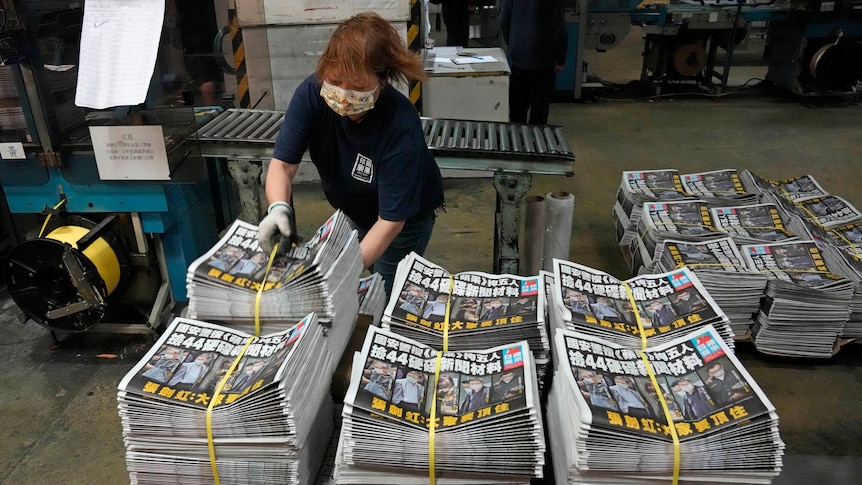 A worker packs copies of the Apple Daily newspaper at the printing house 