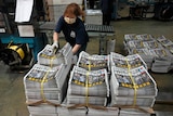 A worker packs copies of the Apple Daily newspaper at the printing house 