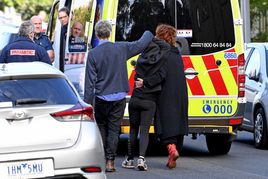 A suspected drug overdose victim is assisted by friends and paramedics in Richmond.