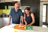 Emilia Habgood and her father Graham Habgood prepare food in a kitchen.