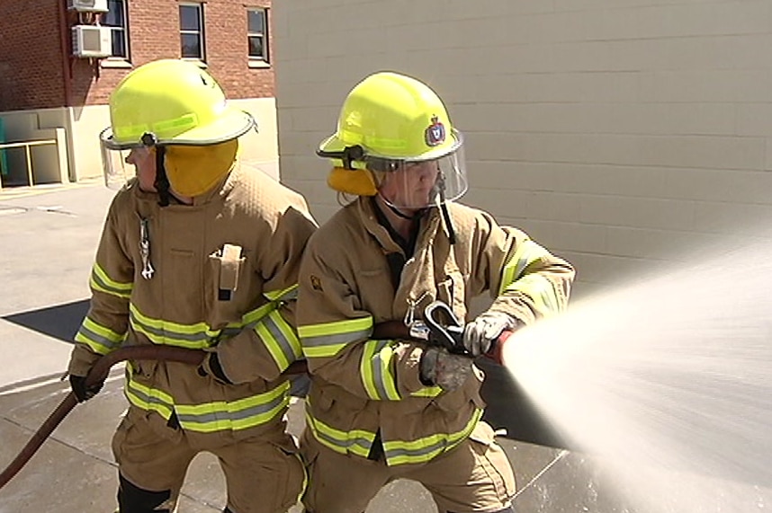 Tasmanian firefighters and a fire hose