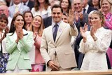 Britain's Kate, Princess of Wales, left, stands in the royal box with tennis champion Roger Federer and his wife Mirka.
