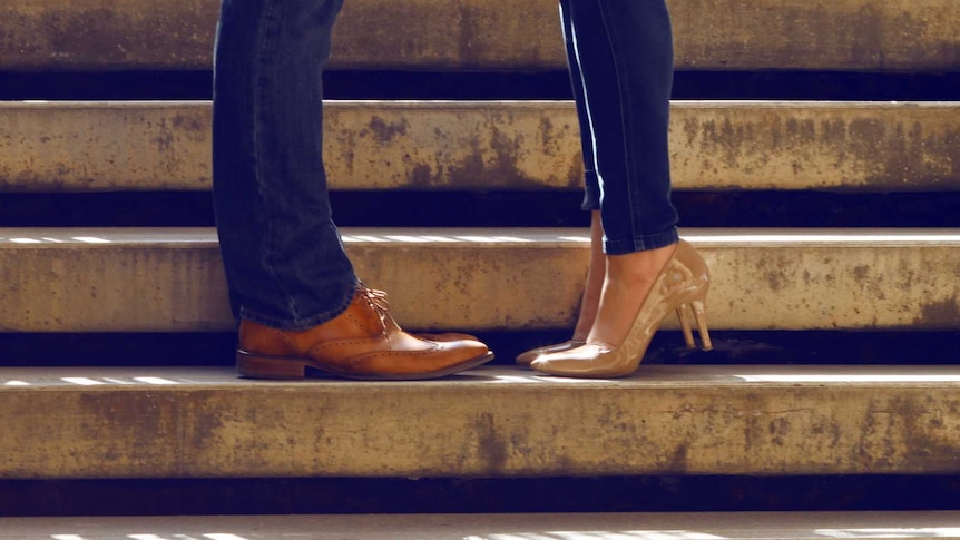 man and woman - legs only with shoes, standing on steps