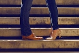 man and woman - legs only with shoes, standing on steps