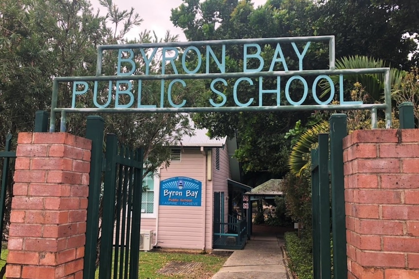 A sign over a gate reads Byron Bay Public School.