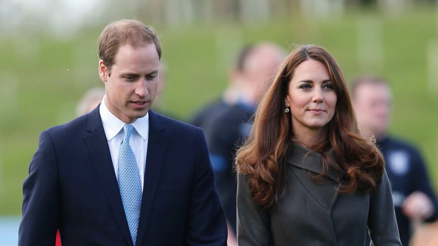 Britain's Prince William walks alongside his wife Catherine, Duchess of Cambridge.
