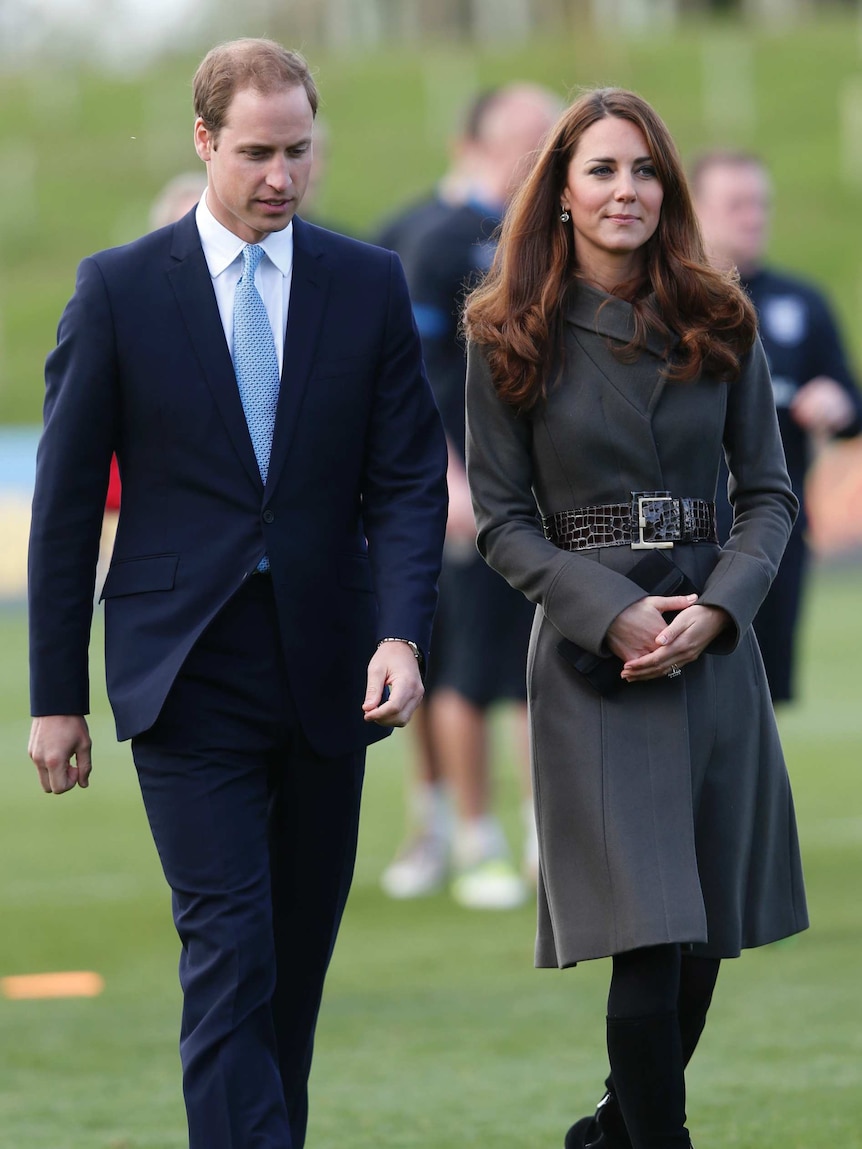 Britain's Prince William walks alongside his wife Catherine, Duchess of Cambridge.