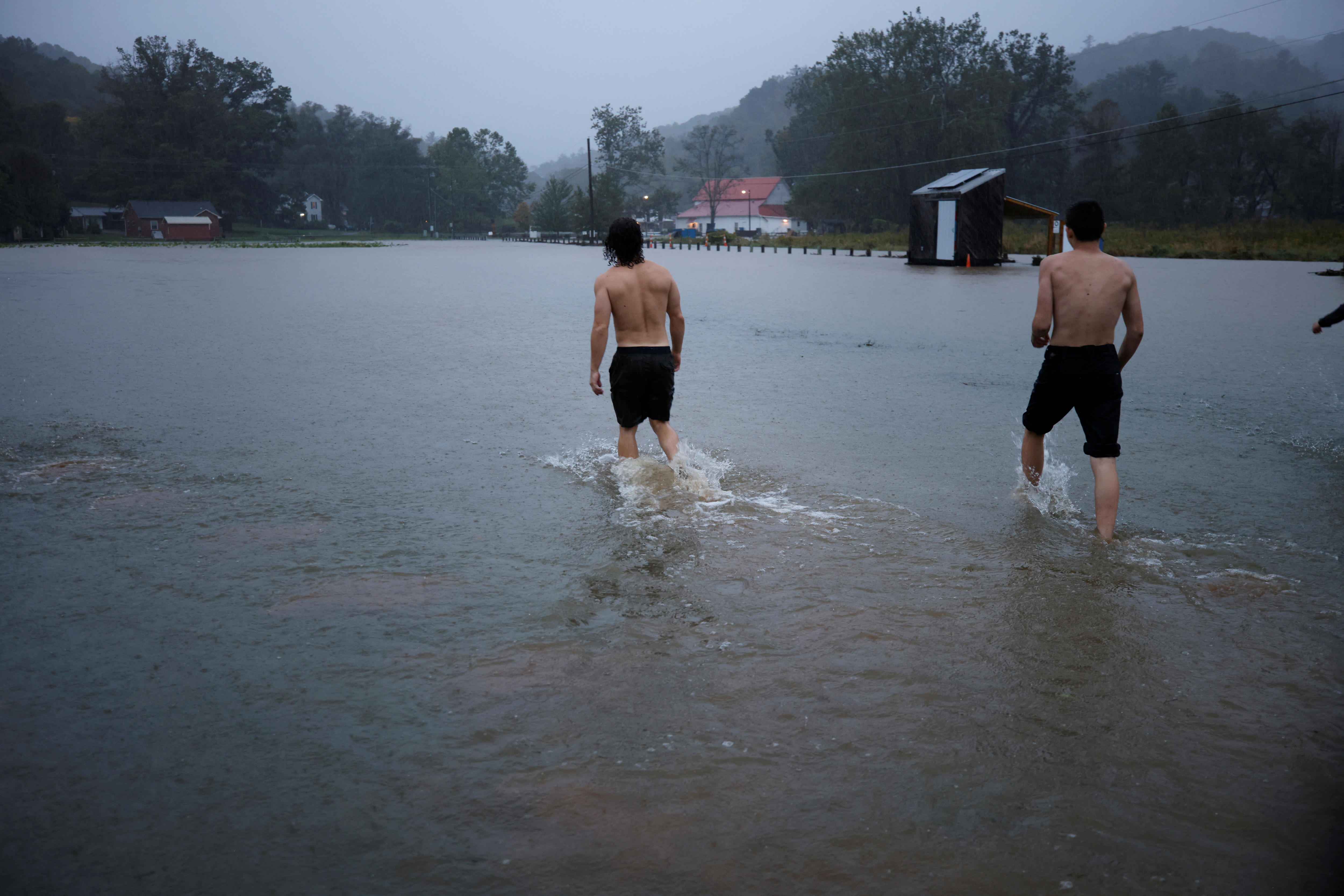 Residents play in flood waters as Hurricane Helene approaches