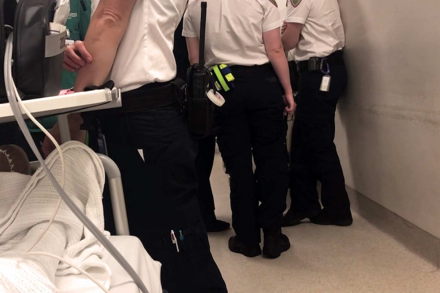 Tasmanian ambulance officers in hospital hallway