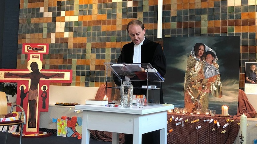 A priest conducts a service at a Protestant church in The Hague