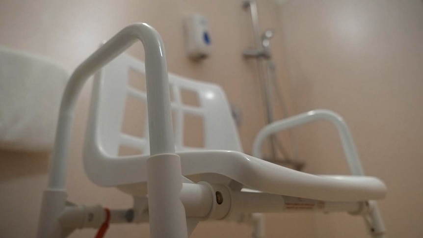 A shower chair sits in the bathroom of a nursing home.